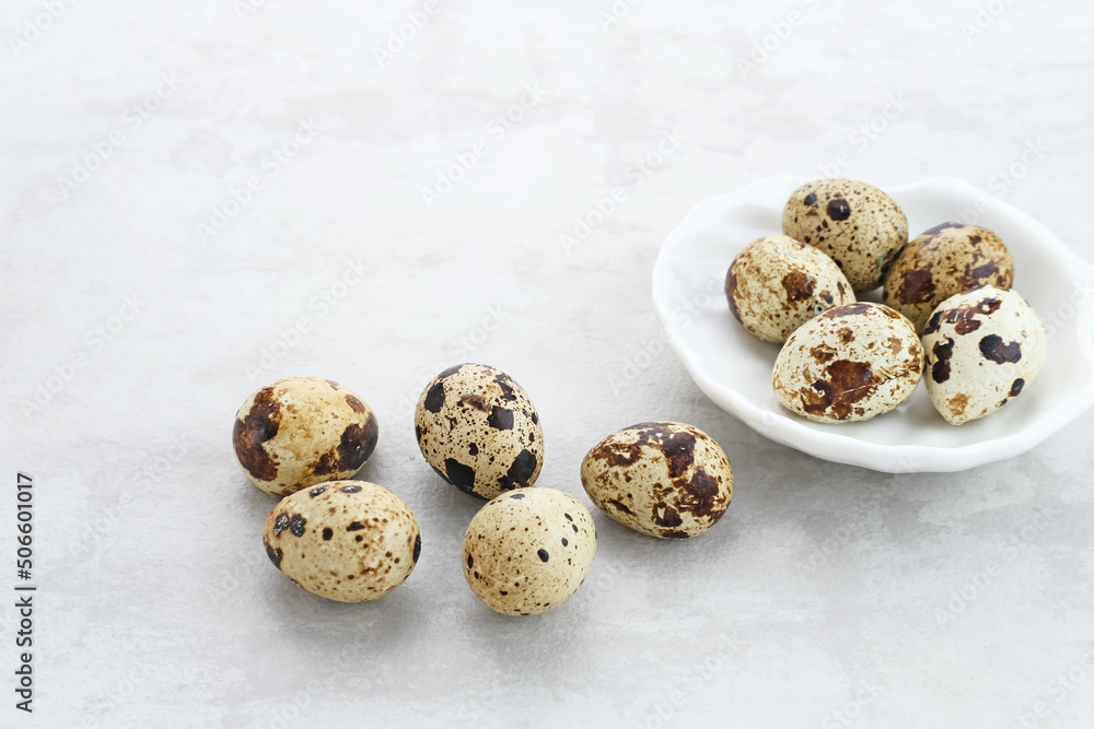 Fresh Quail Eggs served in bowl on grey background. Space for text
Fresh Quail Eggs served in bowl on grey background. Space for text