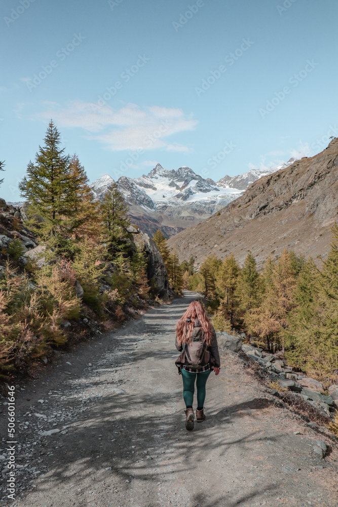 Woman hiking in the mountains in Zermatt.