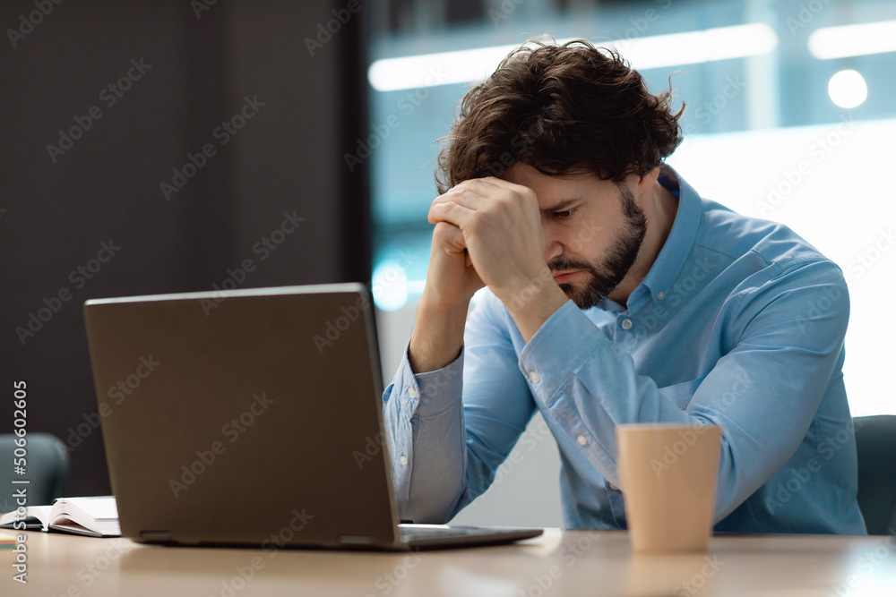 Sad business man grabbing head using laptop Sad business man grabbing head using laptop