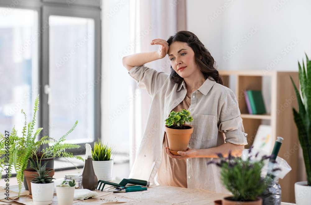 people, gardening and housework concept - tired woman planting pot flowers at home people, gardening and housework concept - tired woman planting pot flowers at home
