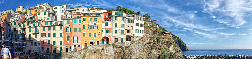 Riomaggiore, Liguria, Italy - June 25, 2021: summer view of the famous touristic village of the Cinque Terre and its sharp cliffs