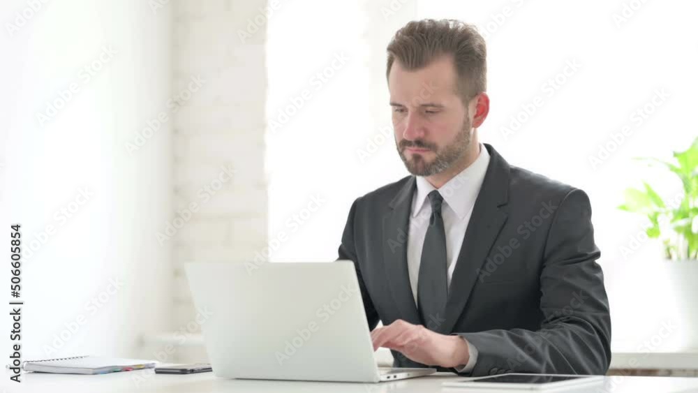 Young Businessman Working on Laptop in Office Young Businessman Working on Laptop in Office