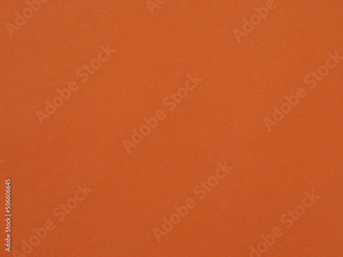 The texture of the dark orange color of the paper as a background