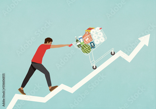 Man pushing shopping cart of groceries up line chart arrow
 photo
