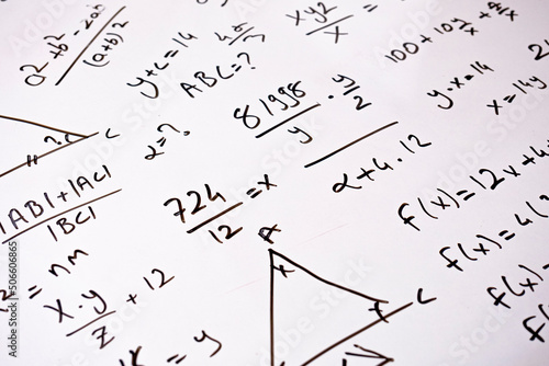 Complicated calculations with black color marker on whiteboard, math idea, formula and calculation, learning mathematic concept, white school board, sitting view