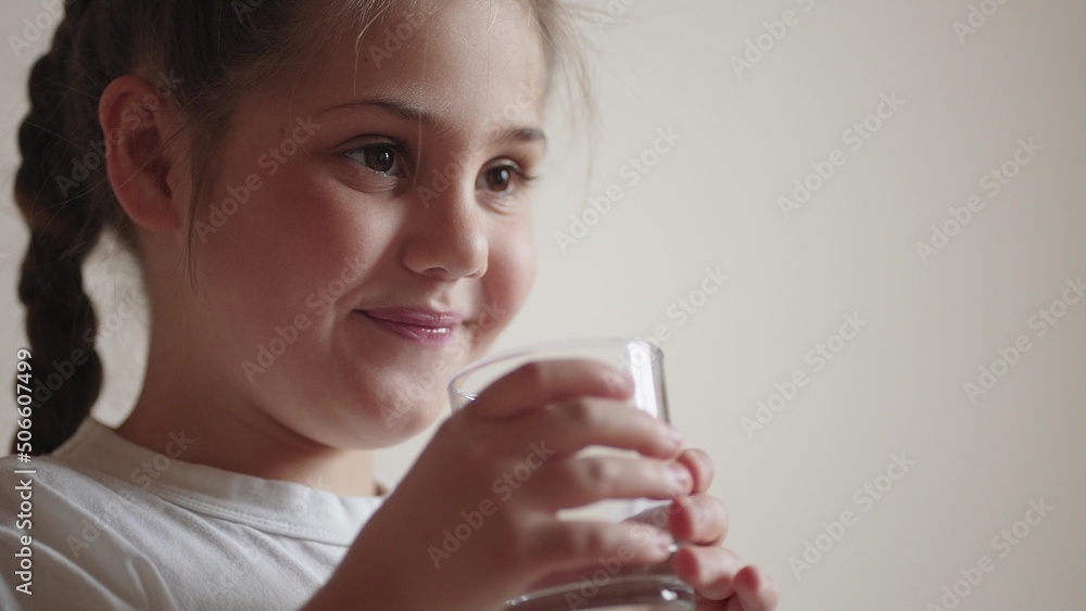 child drinking water. little girl in the kitchen drinks water from a glass cup. lifestyle problem of shortage of drinking water in the world concept. kid drinking clean water from a glass child drinking water. little girl in the kitchen drinks water from a glass cup. lifestyle problem of shortage of drinking water in the world concept. kid drinking clean water from a glass