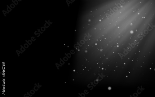 Defocused white lights on a black background.