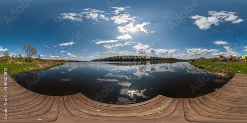 full seamless spherical hdri 360 panorama view on wooden pier of lake or river in sunny day with beautiful clouds and awesome reflection in equirectangular projection, VR content