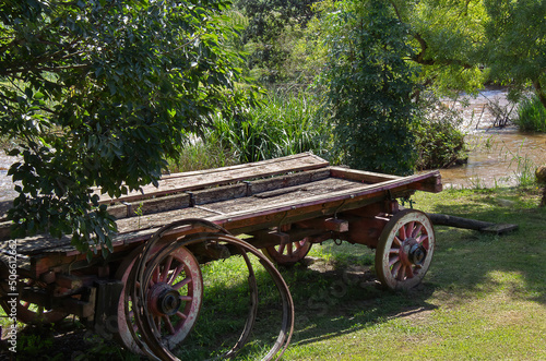 An old wagon next to a stream.