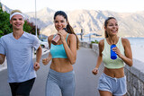 Group of cheerful fit fitness friends team exercising together outdoor. Sport people concept