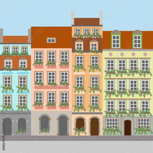 Tableau sur toile Colorful house facades with window boxes with flowers.