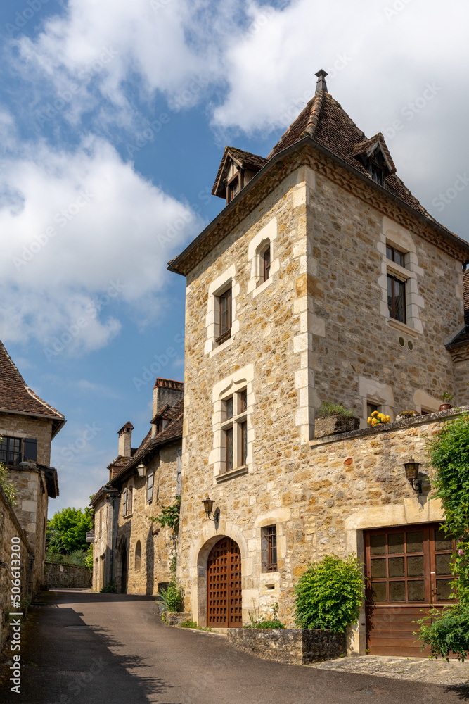 narrow street with stone houses in an idyllic French country village