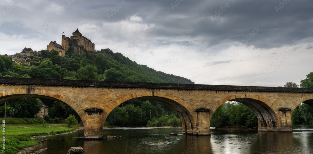 Fototapeta premium the castle in Castelnaud-la Chapelle with the Route de la Pagaie Bridge over the Dordogne River