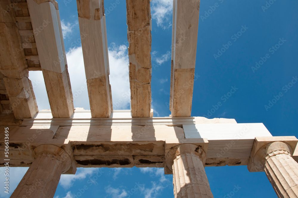 Architectural detail of ancient temple stone columns and rafters ruins on sky background Architectural detail of ancient temple stone columns and rafters ruins on sky background