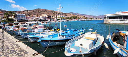View of the port of the mediterranean sea in the summer. Docked boats in the harbor. Elounda, Crete, Greece. © Nigva