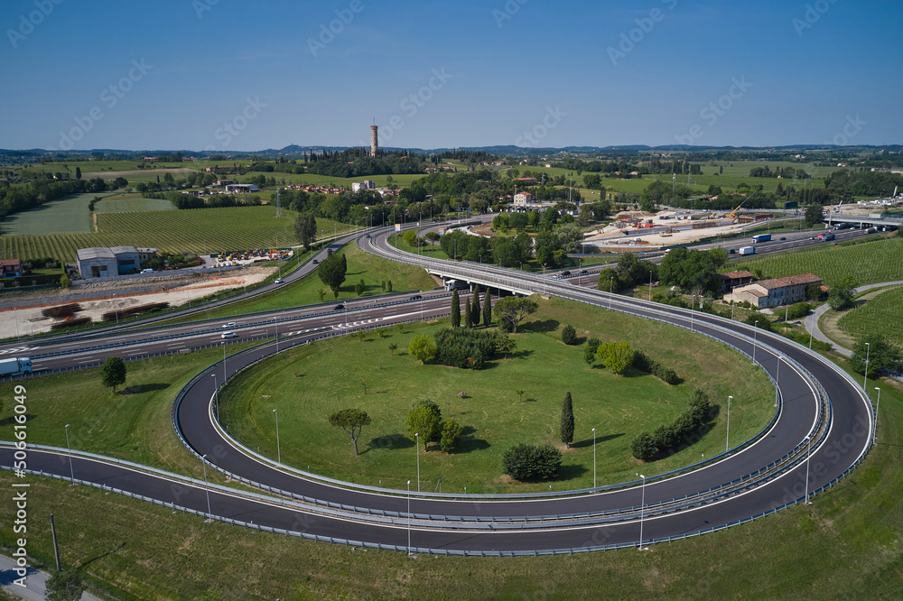 Drone view of Italian motorways. Aerial view of the road junction between the vineyards. Construction of high speed train.