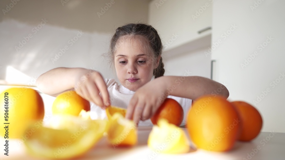 girl child eating oranges. happy family fruit healthy food kid concept. little girl daughter eating oranges at the table in the kitchen indoors dream. juicy fruits oranges are for a healthy diet girl child eating oranges. happy family fruit healthy food kid concept. little girl daughter eating oranges at the table in the kitchen indoors dream. juicy fruits oranges are for a healthy diet
