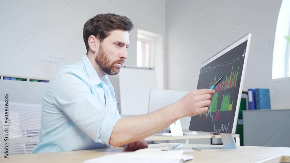 Confident business man stocks broker sitting in front of monitor screen in office analyzing stat of index charts data analyses market trend. Forex trading agency worker agent reviewing profits growth Confident business man stocks broker sitting in front of monitor screen in office analyzing stat of index charts data analyses market trend. Forex trading agency worker agent reviewing profits growth