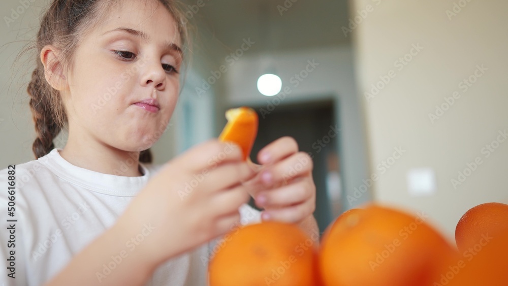 girl child eating oranges. dream happy family fruit healthy food kid concept. little girl daughter eating oranges at the table in the kitchen. juicy fruits oranges are for a healthy diet indoor girl child eating oranges. dream happy family fruit healthy food kid concept. little girl daughter eating oranges at the table in the kitchen. juicy fruits oranges are for a healthy diet indoor