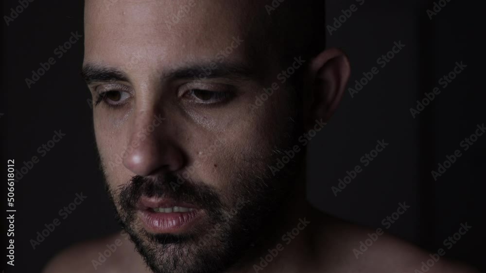 Disturbed man with schizophrenia symptoms. Low key light face with mental disorder Disturbed man with schizophrenia symptoms. Low key light face with mental disorder
