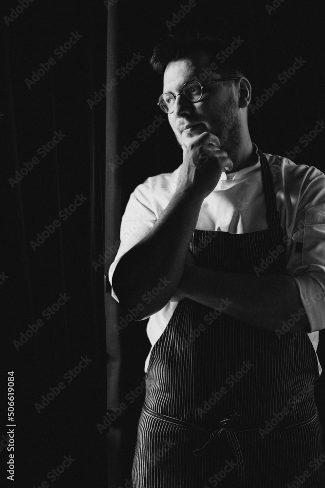 Man chef standing at the kitchen