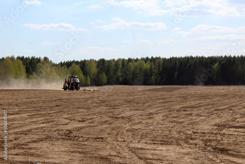 Wallpaper Mural spring sowing the tractor is working in the field Torontodigital.ca