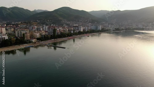 Beautiful view from the air of Pogradec, a town in Albania, Europe by lake Ohrid with mountains in the background during sunset  photo