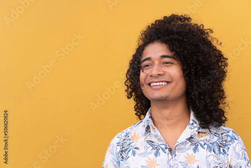 Smiling Man With Curly Hair In City © Hector Pertuz