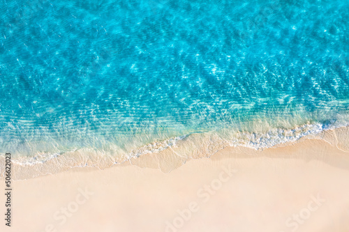 Relaxing aerial beach scene  summer vacation holiday template banner. Waves surf with amazing blue ocean lagoon  sea shore  coastline. Perfect aerial drone top view. Peaceful bright beach  seaside