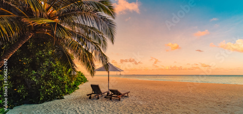 Fototapeta Naklejka Na Ścianę i Meble -  Amazing beach. Chairs on the sandy beach sea. Luxury summer holiday and vacation resort hotel for tourism. Inspirational tropical landscape. Tranquil scenery, relax beach, beautiful landscape design