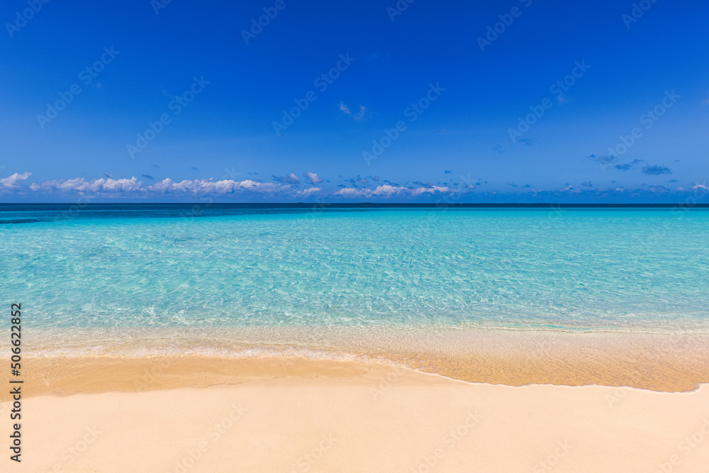Closeup of sand on beach and blue summer sky. Panoramic beach landscape. Empty tropical beach and seascape. Sunny blue sky, soft sand, calmness, tranquil relaxing sunlight, summer mood. Waves shore