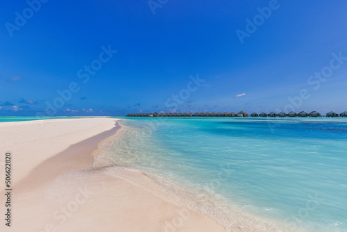 Beautiful panoramic landscape of over water villas, Maldives island, Indian Ocean. Luxury tropical vacation, exotic lagoon, crystal clear water, relaxing blue sky sea. Summer travel tourism paradise