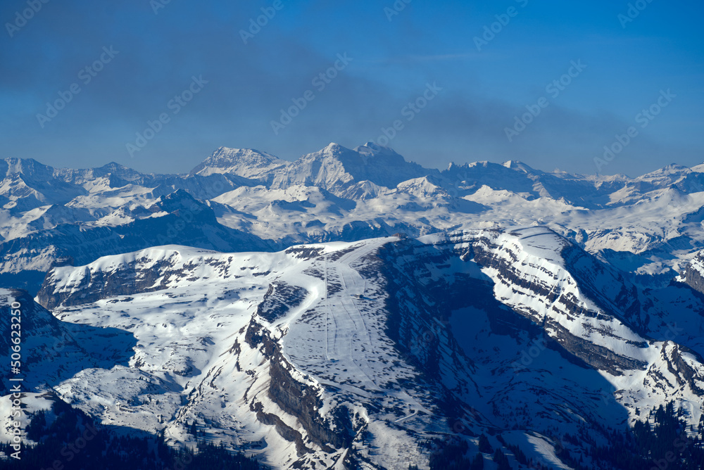 Aerial view over the Swiss Alps with Churfirsten and Toggenburg Valley seen from Säntis peak at Alpstein Mountains on a sunny spring day. Photo taken April 19th, 2022, Säntis, Switzerland.