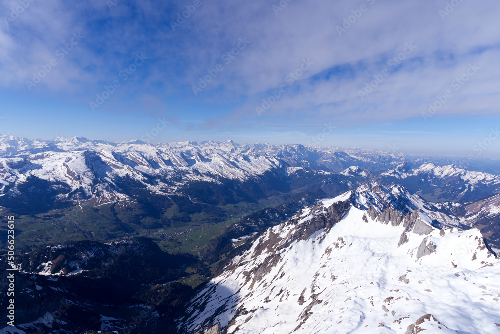 Aerial view over the Swiss Alps seen from Säntis peak at Alpstein Mountains on a sunny spring day. Photo taken April 19th, 2022, Säntis, Switzerland.