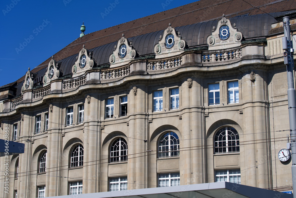 Stone facade of railway main station of City of St. Gallen on a sunny spring day. Photo taken April 19th, 2022, St. Gallen, Switzerland.
