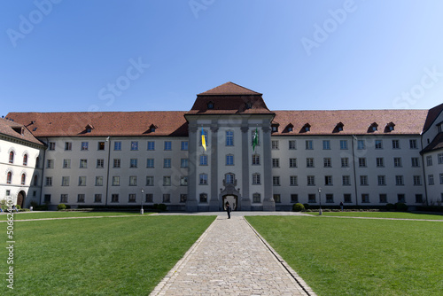 Flags of Canton St. Gallen and the Ukraine at government building blowing in the wind on a sunny spring day. Photo taken April 19th, 2022, St. Gallen, Switzerland. © Michael Derrer Fuchs