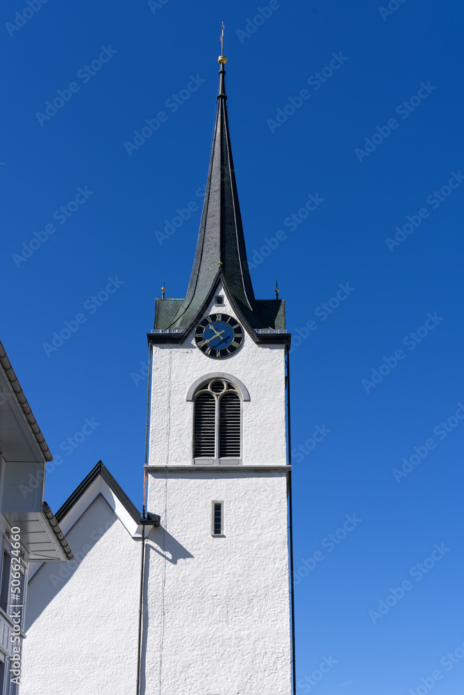 Protestant church tower at village Urnäsch on a sunny spring day. Photo taken April 19th, 2022, Urnäsch, Canton Appenzell Ausserrhoden, Switzerland.