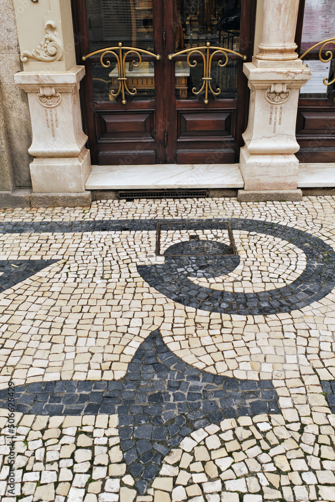 detail of the entrance door, the pavement and the facade of the Majestic café in Porto, Portugal