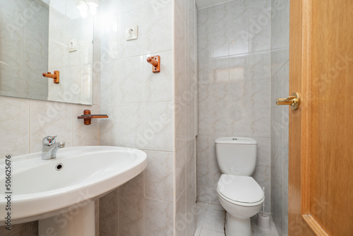 Toilet with white porcelain sanitary ware  square frameless mirror and wooden door