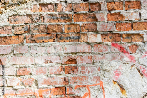 Damaged brick wall. Red brick. Brickwork on an old wall.