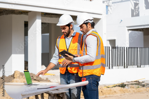 Photos Team engineer and architects are meeting to plan for new project measuring layout of building blueprints in construction site,Construction residential new house in progress at building site