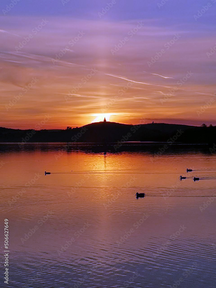 Watchtower on top of mountain in the rays of a scarlet sunset