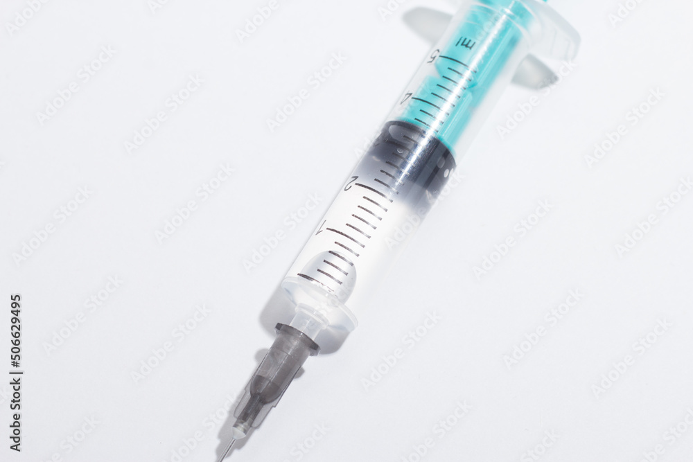 Medical syringe on a white background. A syringe for injection. The concept of health and beauty Medical syringe on a white background. A syringe for injection. The concept of health and beauty