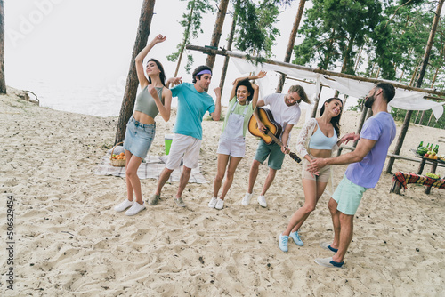 Portrait of attractive friends friendship buddy fellow spending day dancing relax festive camp at beach picnic outdoors