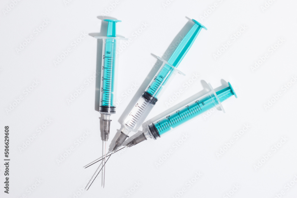 Medical syringe on a white background. A syringe for injection. The concept of health and beauty Medical syringe on a white background. A syringe for injection. The concept of health and beauty