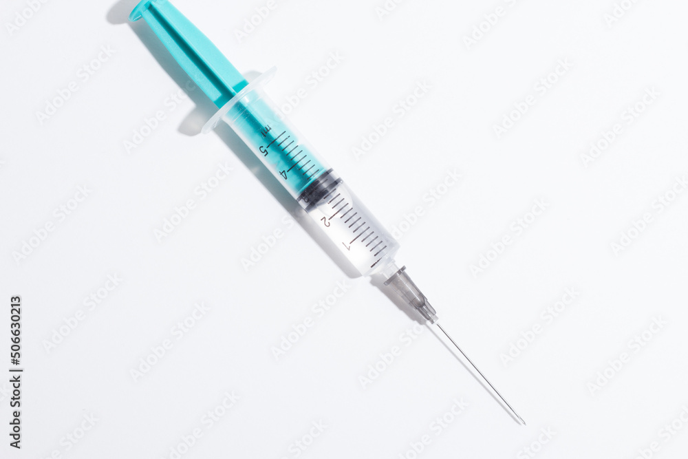 Medical syringe on a white background. A syringe for injection. The concept of health and beauty Medical syringe on a white background. A syringe for injection. The concept of health and beauty