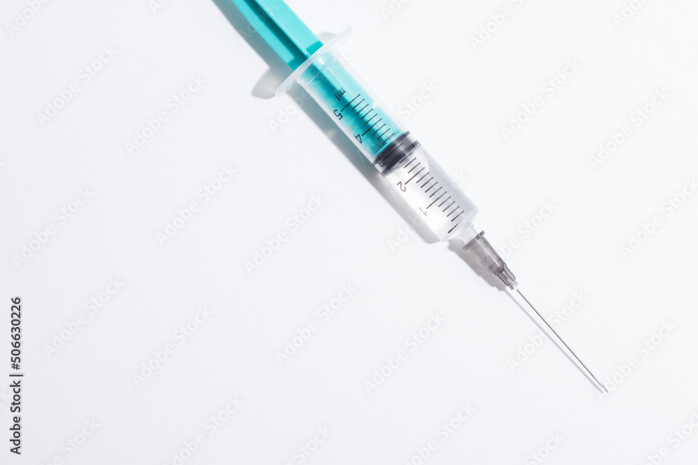 Medical syringe on a white background. A syringe for injection. The concept of health and beauty Medical syringe on a white background. A syringe for injection. The concept of health and beauty