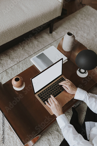 Aesthetic minimalist home office workspace desk. Person working on laptop computer. Blank mockup screen template. Work, business concept