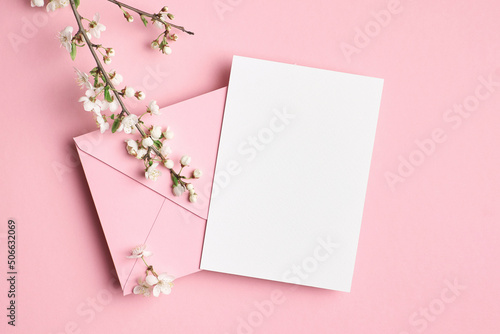 Blank invitation card mockup with envelope and flowers