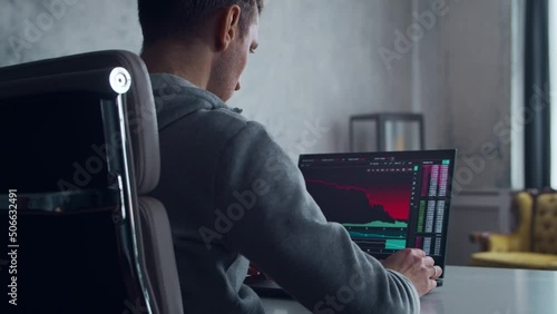 Cryptocurrency Trader at his Workplace in front of a Computer. Laptop Monitor with Stock Correction Chart. Business, Stock and Crypto Trading Concept. photo